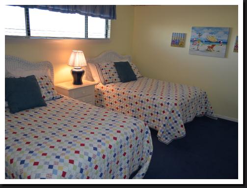 rear guest bedroom with two full beds.